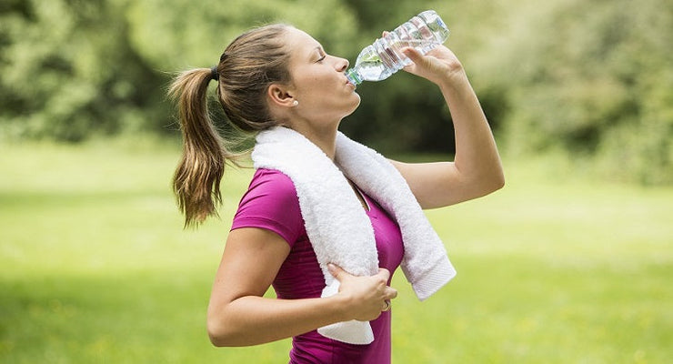 woman drinking water from bottle