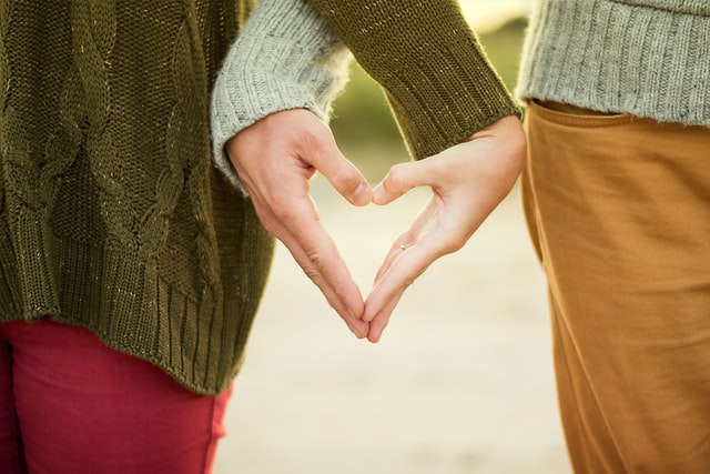 Couple making heart shape with hands