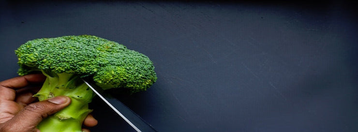 hand cutting broccoli floret