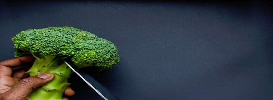 hand cutting broccoli floret