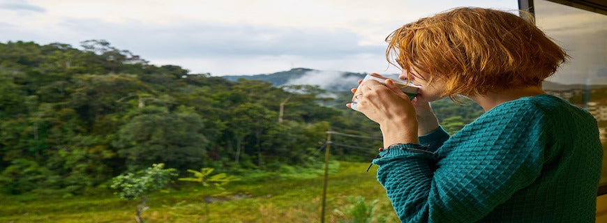 woman sipping coffee at window