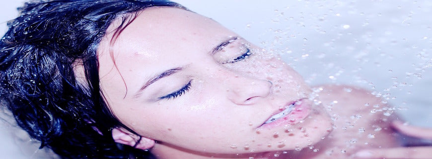 white woman's face, standing under shower