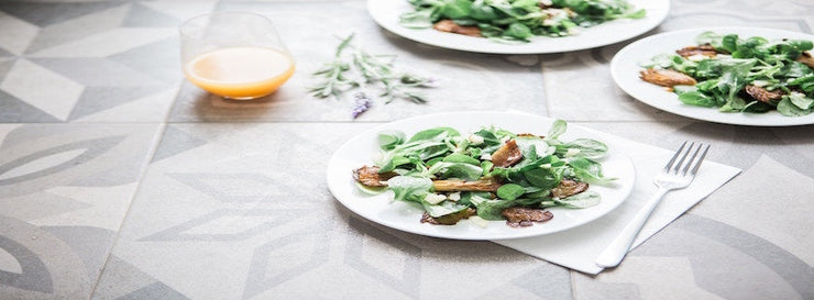 two plates containing salad