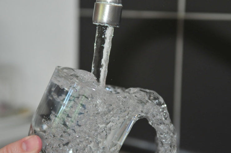 tap filling glass with water