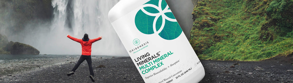 Bottle of multiminerals on background of person jumping by a waterfall